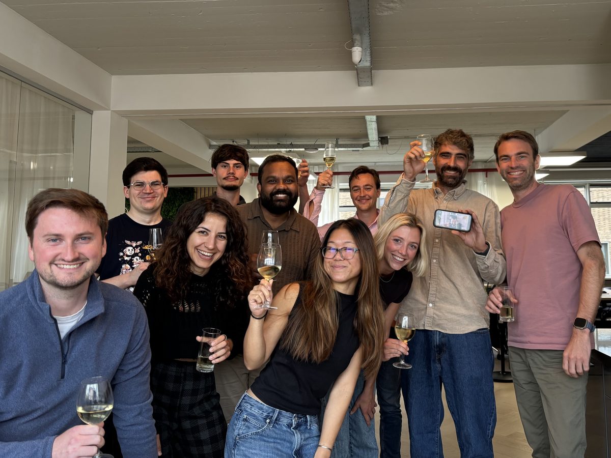 The Koalitix team raising a glass of wine in the office.